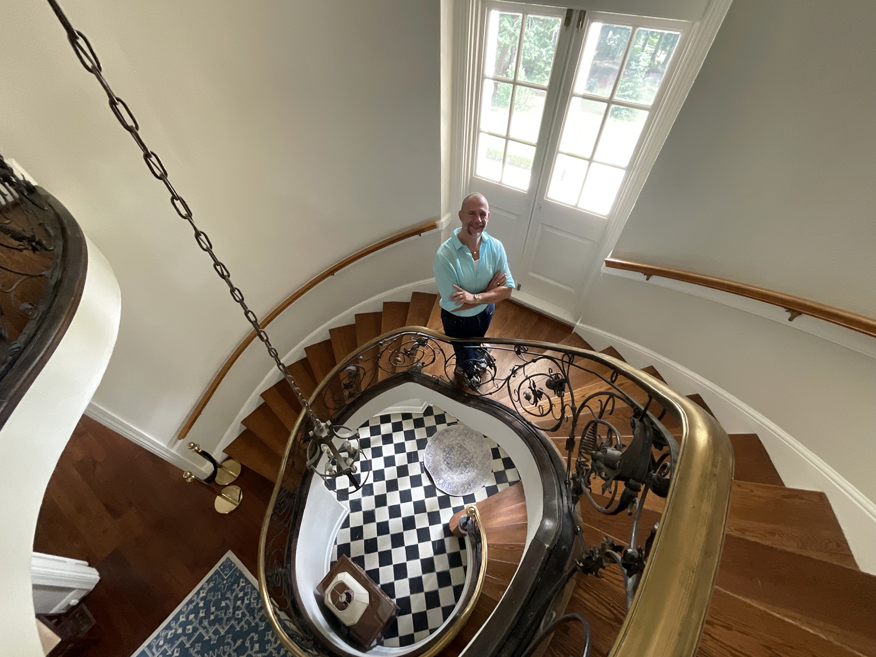 Cator Sparks on the spiral staircase at the front entrance of the Cator Woolford houe.