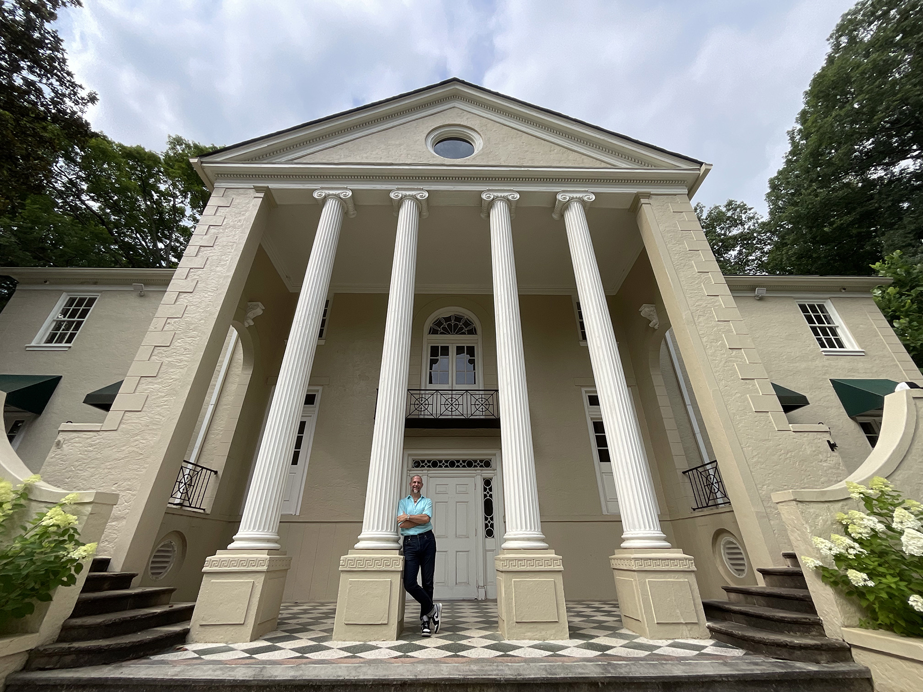 Cator Sparks in front of the home his great-grandfrather built.